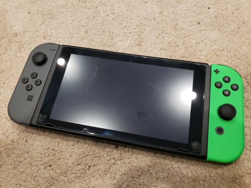 Nintendo Switch with soft, hard, and carrying case – green and black joycons