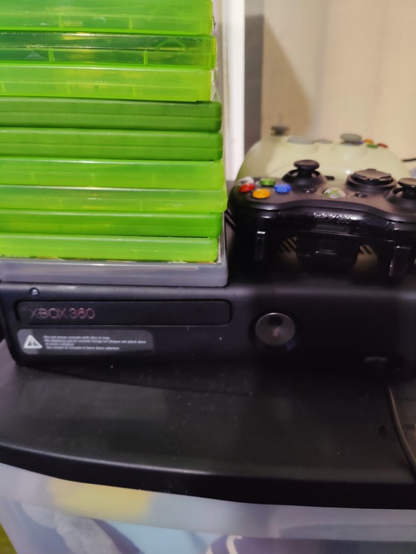 Xbox 360 Slim with two controllers and many games